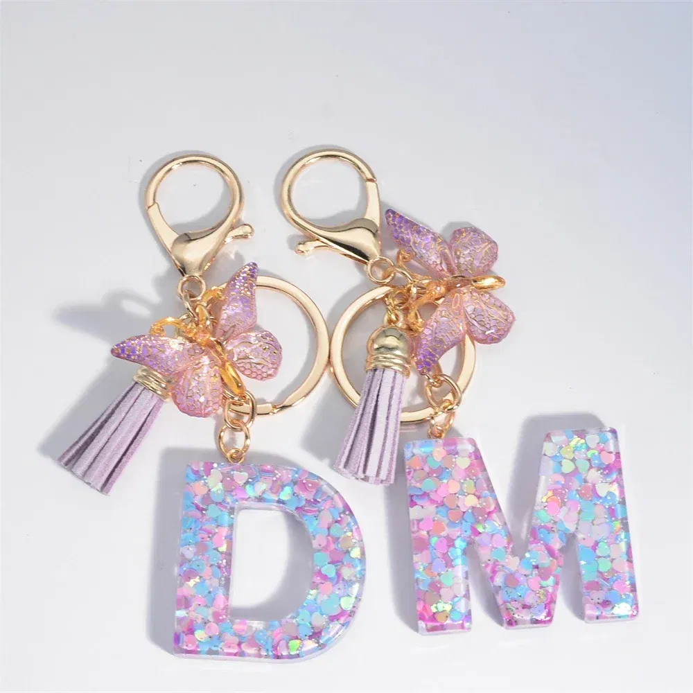 Color: Dark Khaki - Fashion Tassel Butterfly 26Letter Keychain Colorful Love Heart Filled Resin Alphabet Keyring Women Girls Car Bag Phone Pendant