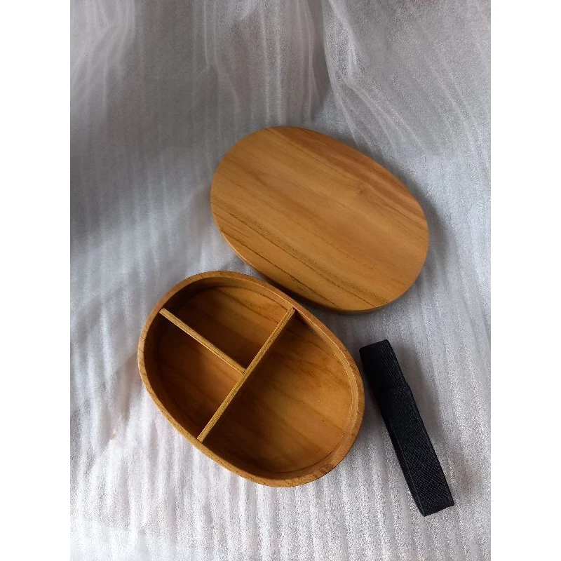 Child size oval food storage box made of wood